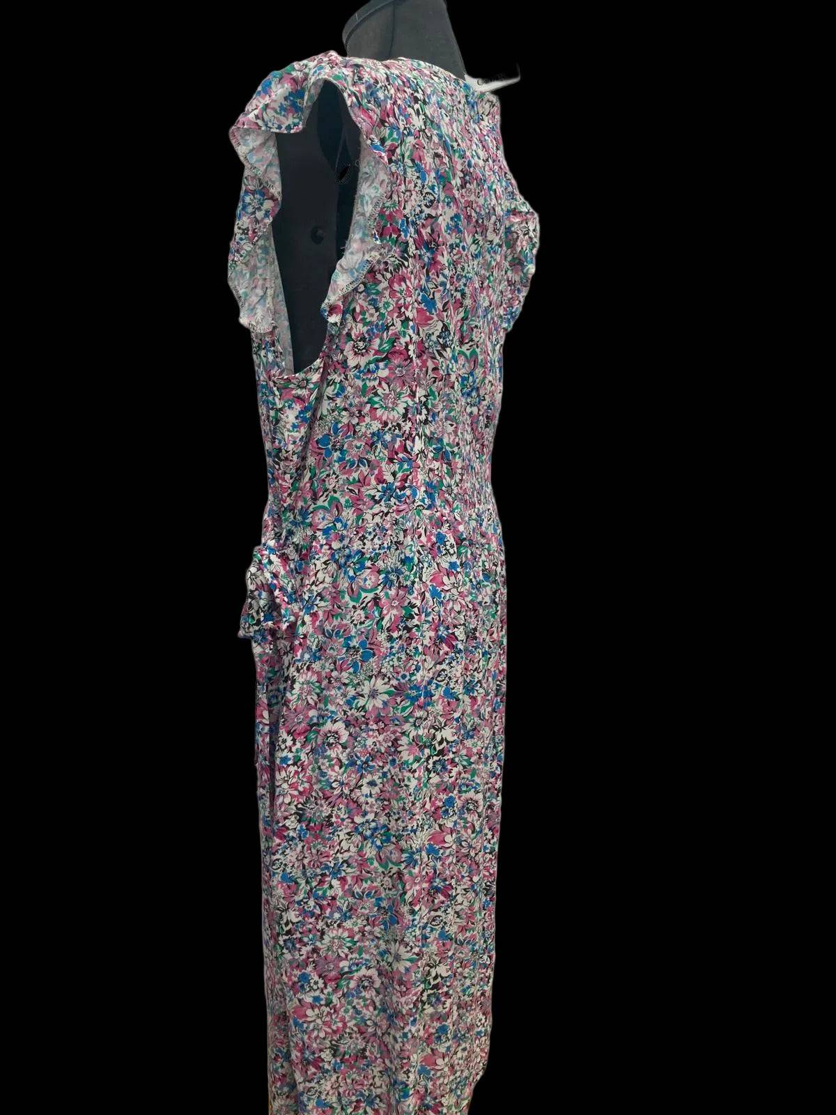 Back view of floral wrapover dress on mannequin