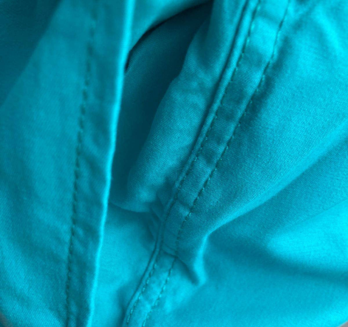 Inner label of turquoise swim shorts with mesh lining
