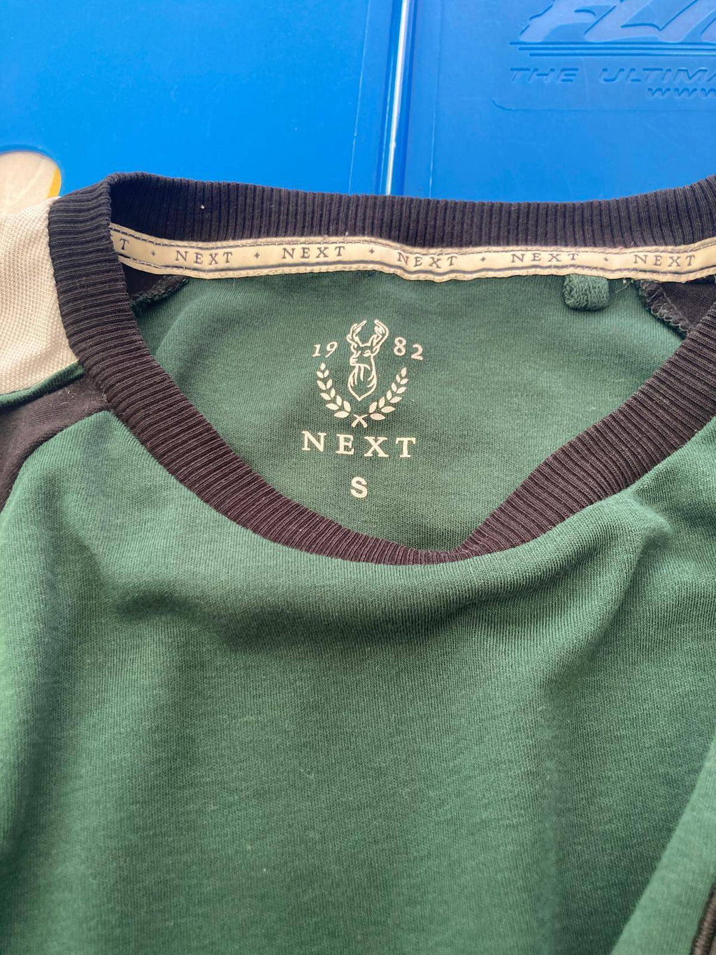 Close-up of T-shirt collar with brand label