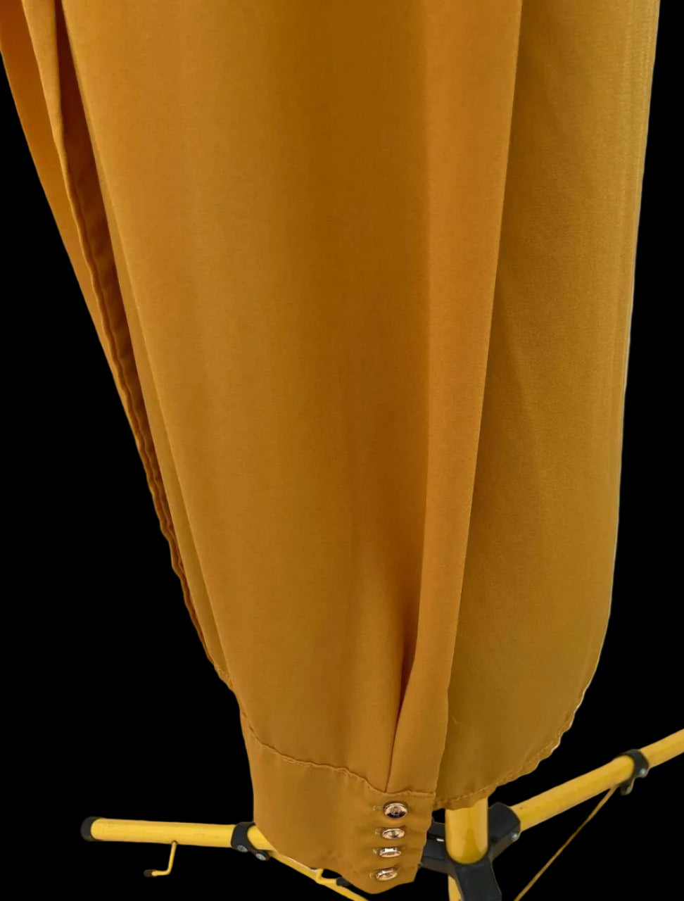 Close-up of mustard yellow blouse fabric and button details