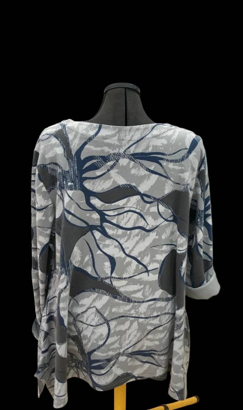 Back view of stylish abstract print top with rolled sleeves