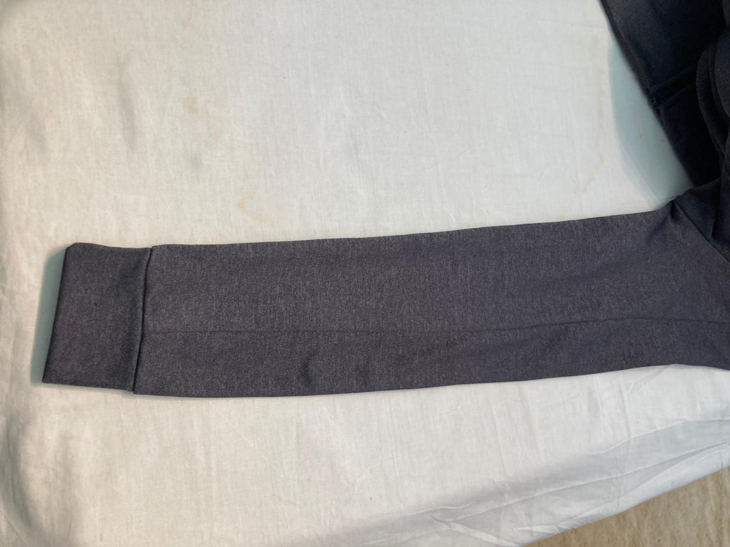 Gray athletic jacket sleeve with logo tag